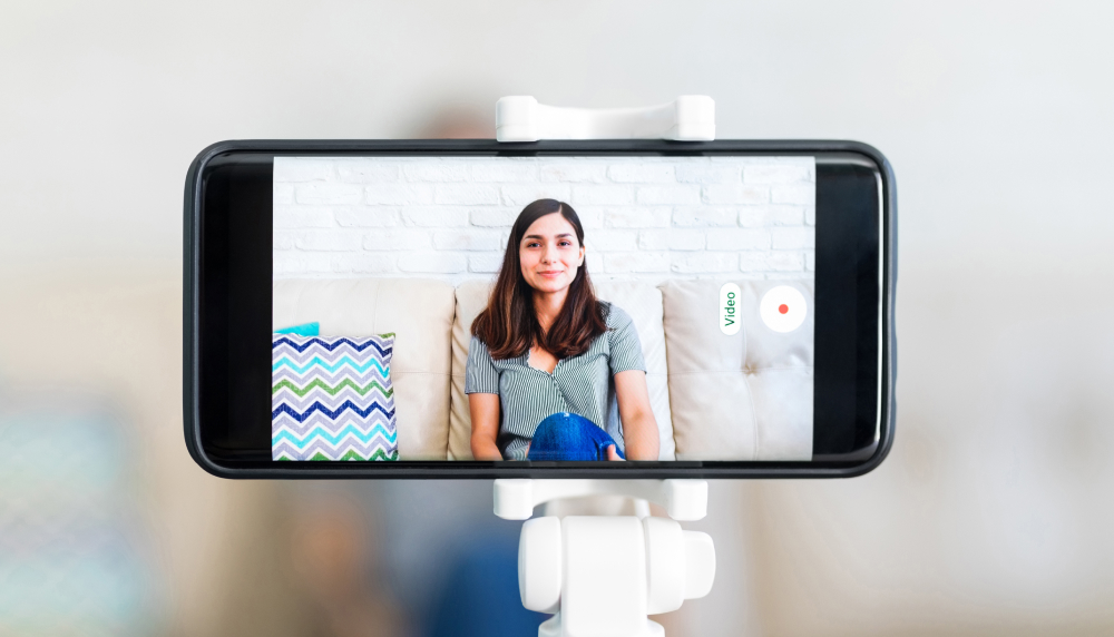 Student recording herself on smart phone.